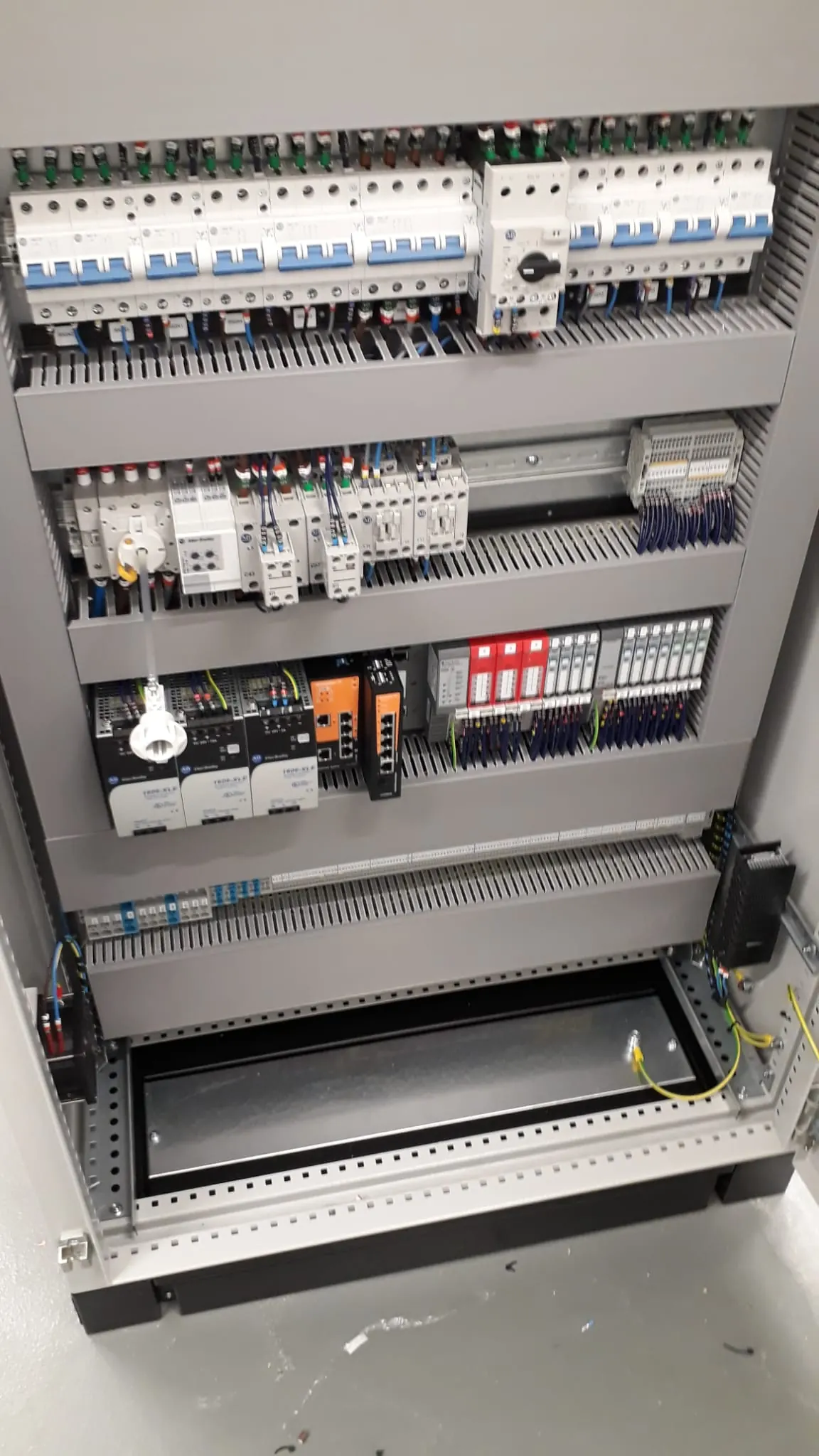 Control panel with rows of breakers, contactors and grey trunking