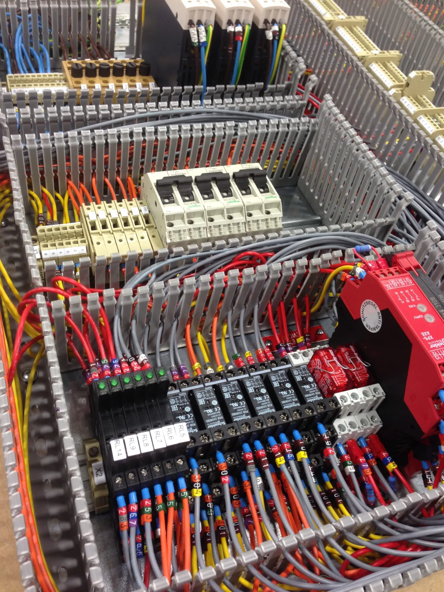 Wired control panel with a red safety relay and terminals