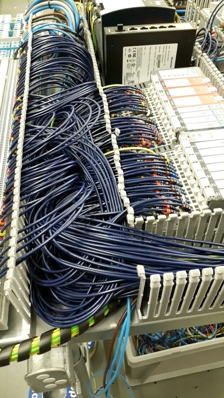 Dark blue wiring run through trunking