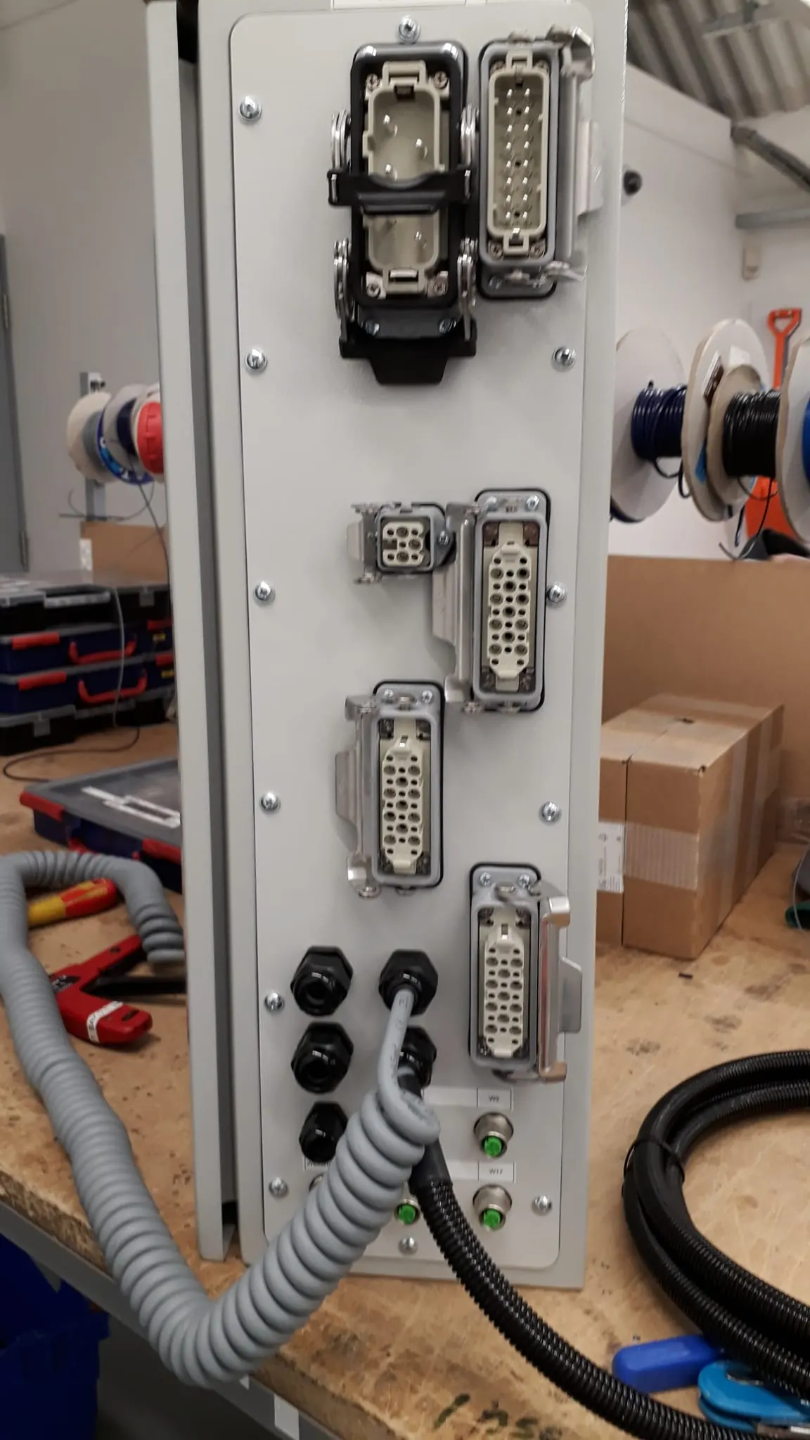 Industrial connectors on the side of an enclosure