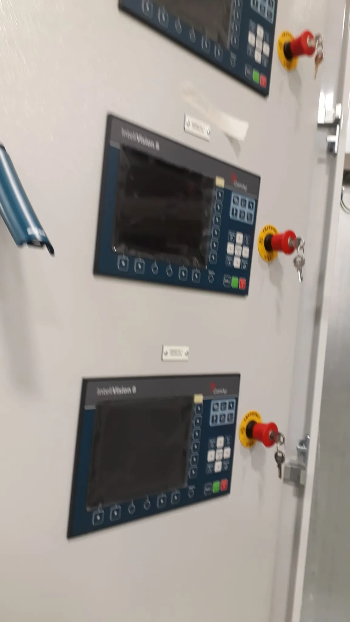 Operator screens and emergency stops on a panel door